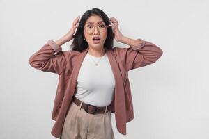 Sad Asian woman wearing eyeglasses looking stressed and depressed or having headache, isolated white background. photo