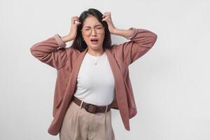 Sad Asian woman wearing eyeglasses looking stressed and depressed or having headache, isolated white background. photo