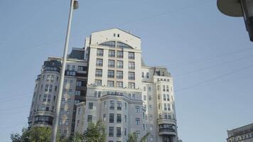 Moscow residential complex. Action. A multi-storey building next to trees against a blue sky background. video