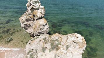 Sea view located next to the mountains.Action. Drone view of a beautiful seascape on large rocks near the sea and high hills. video