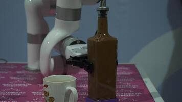 Close-up of robotic hand pouring drink. HDR. Cybernetic hand trains to pour drinks. Creation and improvement of robotics and cyborgs video