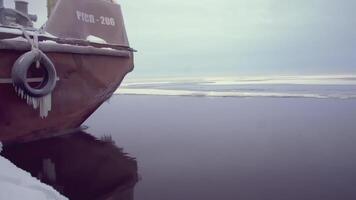 Large barge at the North Pole. CLIP. In the foreground Rope with icicles. In the background, a heavy barge in ice water is in focus. A ship pulling a barge in tow video