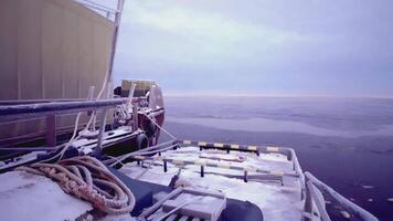 Two barges in the snow in the cold sea. CLIP. Close-up on the interior of the barge. There is a shipping container on a nearby barge video