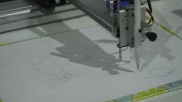 A machine that draws pictures and graphics. HDR. Robot machine that draws on a piece of paper. video