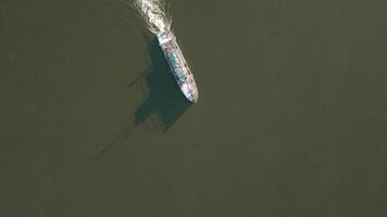 Winter bird's-eye view. Clip. Cargo ships moving along the river and carrying cargo. video