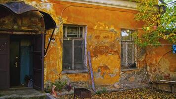 Old residential building facade with scuffed plaster. Stock footage. Old apartment building on a sunny day. video