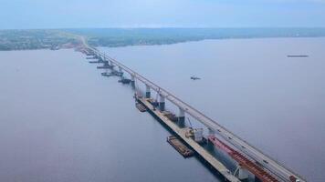 A huge Crimean bridge with cars. Clip . The view from the drone. A huge bridge with traffic on the background of the sea and a huge forest around. video