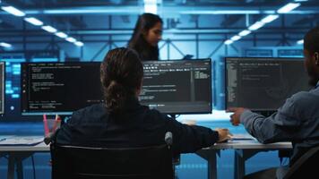 Person with paraplegia working in inclusive workplace typing data on PC, doing needed adjustments in supercomputers server hub housing advanced data storage infrastructure video