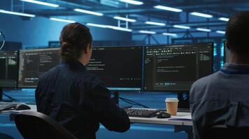 Manager overseeing server room and drinking coffee while running code on PC, troubleshooting hardware. System administrator programming in server farm on computer and enjoying hot beverage video