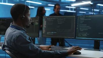 IT support worker remotely collaborating with experts to fix servers providing computing resources for workloads. Man using headphones mic to talk with manager supervising data center supercomputers video