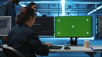 Engineer in server hub using green screen PC to repair equipment storing datasets. Professional using mockup computer to do debugging on rigs doing computational operations video