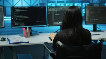 Woman with impairment in server farm looking over hardware parameters on clipboard files. Wheelchair user in data center reading paperwork, reviewing rigs performance video