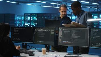 Man inspecting server farm, reading paperwork, following inspection checklist, talking with employees. Supervisor doing checkup in data center workplace, verifying reports files video