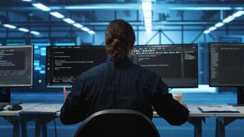 Engineer drinking coffee and programming in server room with equipment storing datasets. Employee enjoying caffeine beverage, typing code on PC to mend data center racks doing computational operations video