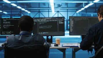 Person with disability next to multiracial coworkers in data center coding on computer. Wheelchair user and multiethnic team working together, doing programming, overseeing server clusters video