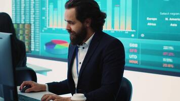 Corporate employee looking into project details and timetables in open coworking space, establishing budget and operations to accomplish goals in a competitive environment. Camera A. video