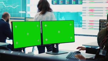 Executive officer analyzing greenscreen on monitors at his workstation, find ways of increasing organizational funds to expand the business globally. Isolated mockup screen in control room. Camera A. video