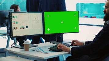 Sales manager examining success and efficiency metrics within the firm, reviews progress details next to isolated display on pc. Administrator evaluating statistics and team productivity. Camera A. video