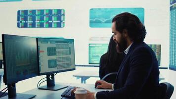 Corporate employee looking into project details and timetables in open coworking space, establishing budget and operations to accomplish goals in a competitive environment. Camera B. video