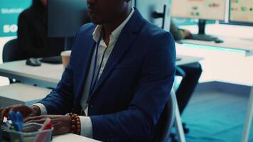 Chief executive officer reviewing project details about achieving business goals, establishing resource allocation. Administrator works in a firm monitoring room with big screen. Camera A. video