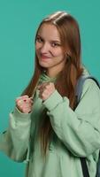 Vertical Woman doing fighting stance, pretending to do boxing, isolated over studio background. Young fighter throwing punches, doing athletic guard pose during combat practice, camera A video