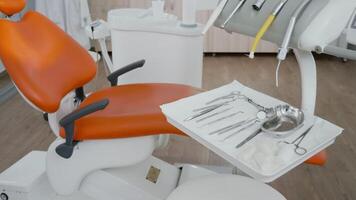 Close up revealing shot of medical dental tools ready for stomatology teeth surgery in orthodontic workplace. Orthodontist office equipped with professional tooth instruments ready for healthcare video