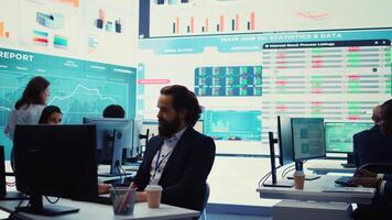 General manager working on data management with infographics and business activity reports, ensuring objective achievement. Shareholder reviewing an investment for global expansion. Camera B. video