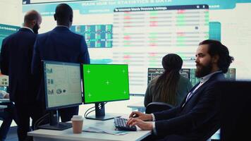Sales manager examining success and efficiency metrics within the firm, reviews progress details next to isolated display on pc. Administrator evaluating statistics and team productivity. Camera B. video