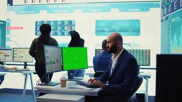 Chief financial officer reviews cost and revenue numbers next to a greenscreen, working on data management study for future improvement. Accountant ensures organizational success. Camera B. video