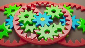 Looping 3D animation multi-colored plastic toy gears. video