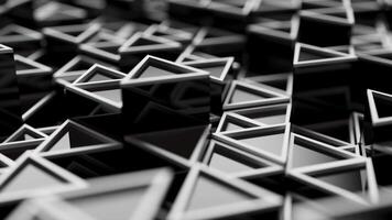 Looping animation of a group of black plastic triangular geometric shapes. video