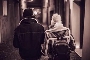 Young Couple Walking in a Nighttime Alley photo