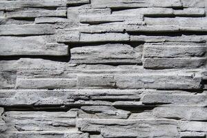 Stonework with asymmetry as texture, background photo