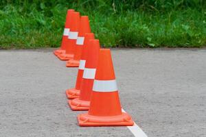 Orange traffic cones standing in a row photo