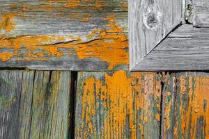 Aged painted wooden wall planks with fragment of the window frame as texture, background photo