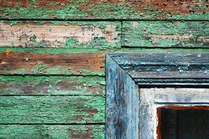 Aged painted wooden wall planks with fragment of the window frame as texture, background photo