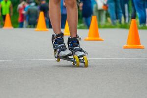 legs in roller skates skating on road photo