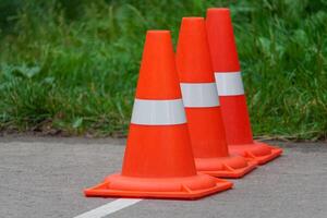 Orange traffic cones standing in a row photo