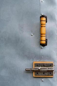 fragment of a door with a handle and latch as background, texture photo