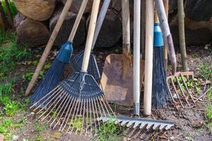 Old dirty garden tools, cultivator, shovel, rake photo
