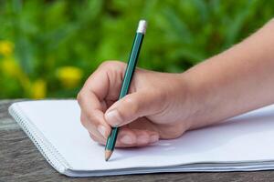 kid's hand draws in pencil photo