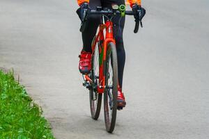 Bicyclist on the asphalt road in the park photo