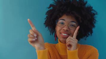 a woman with glasses and an afro is pointing at something photo