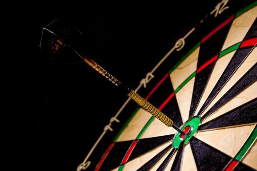 Fragment of target with dart in bullseye photo