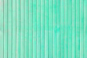 Vertical wooden planks painted turquoise as background, texture photo