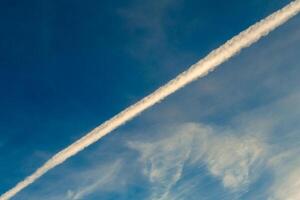 Condensation trace in the sky photo