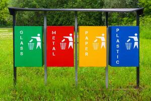 Four colors recycle bins or trash can in the park photo