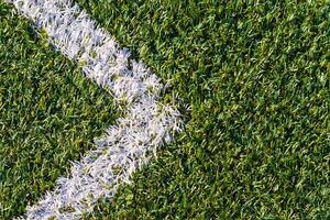 Sports field with artificial grass and white markings as arrow photo