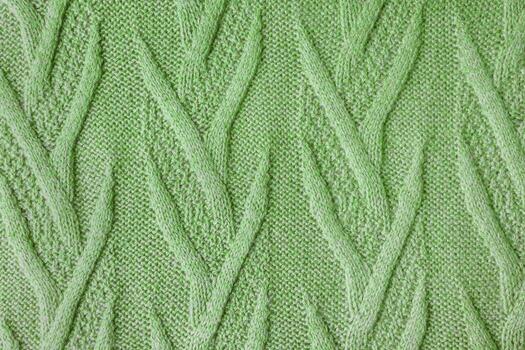 Knitted from the wool with an openwork pattern background photo
