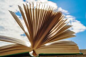 Open book against a clear sky photo